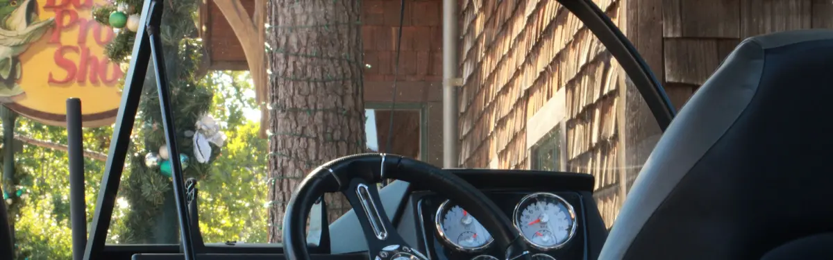 Boat helm and dashboard with gauges and steering wheel